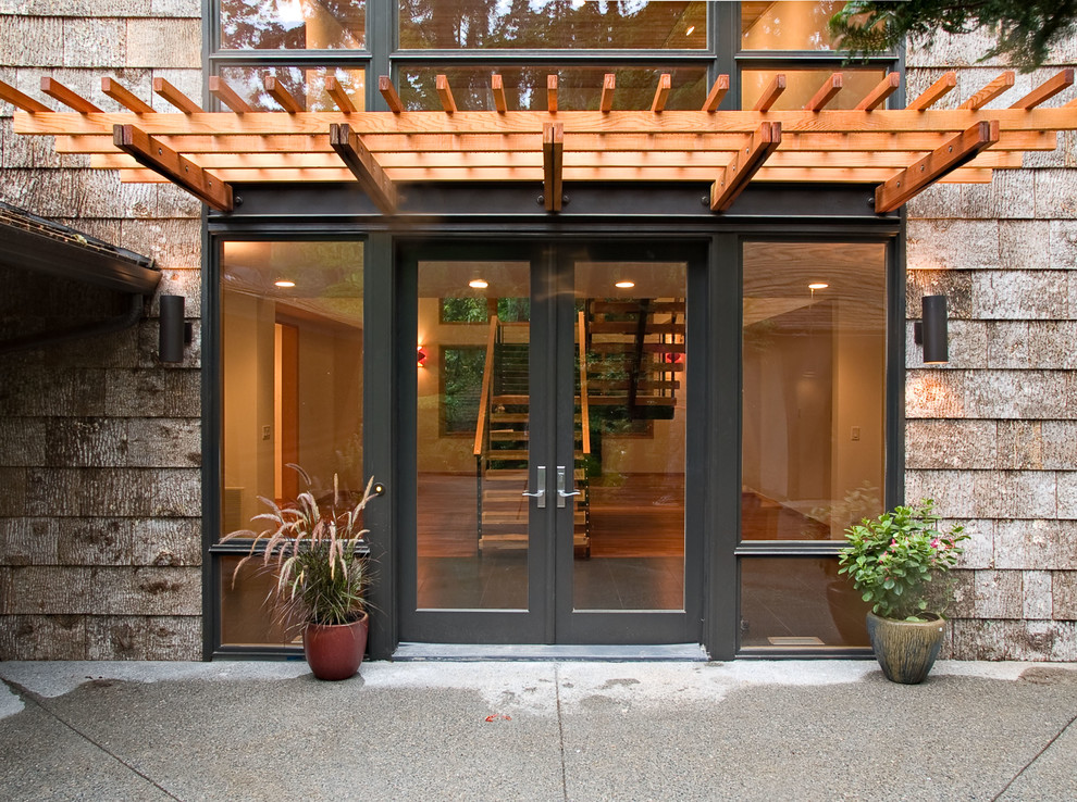 This is an example of a contemporary front door in Seattle with a double front door and a glass front door.