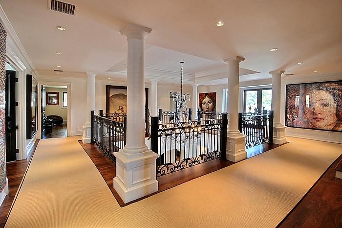 Example of a huge tuscan marble floor entryway design in Miami with white walls and a dark wood front door