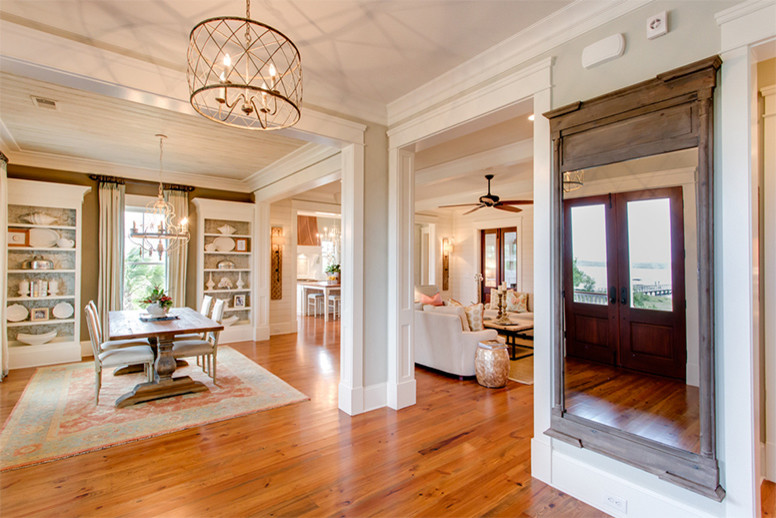 Example of a large beach style medium tone wood floor foyer design in Charleston with beige walls