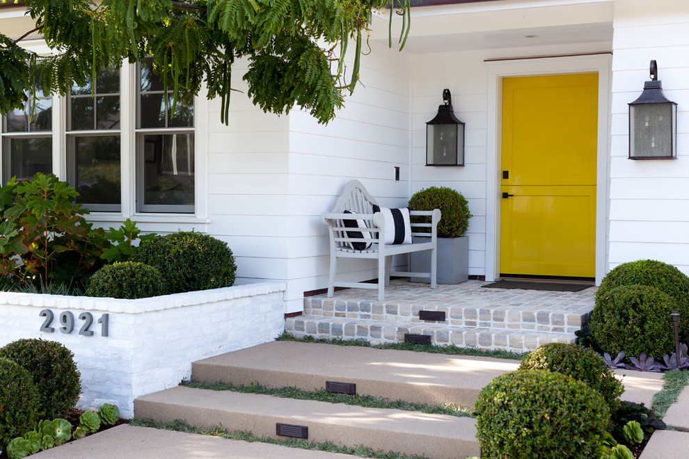 Elegant entryway photo in Orange County with a yellow front door