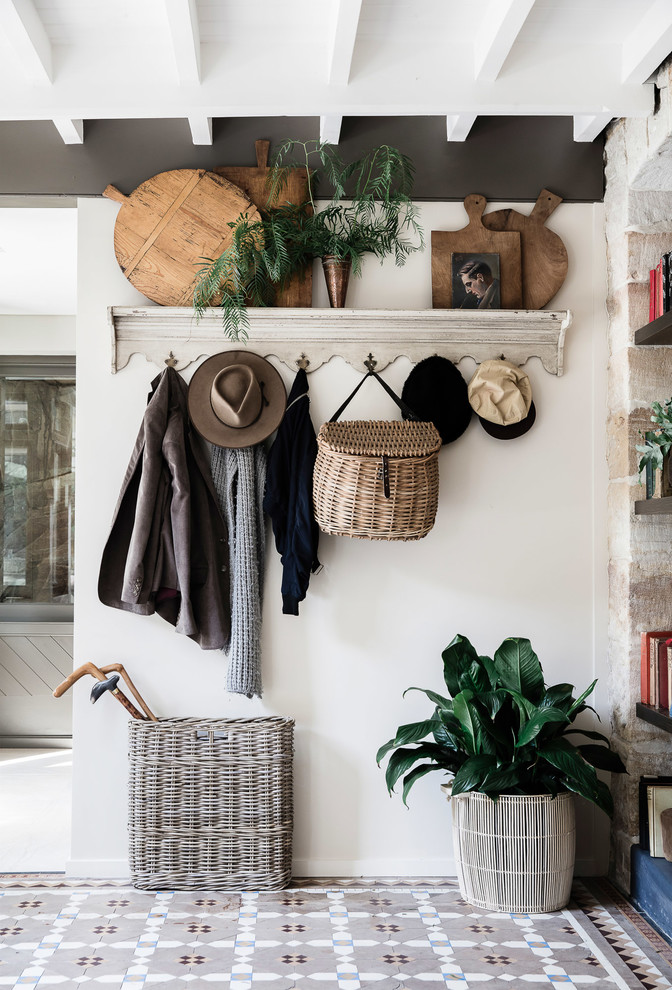 Photo of a traditional hallway in Sydney with white walls, ceramic flooring and grey floors.