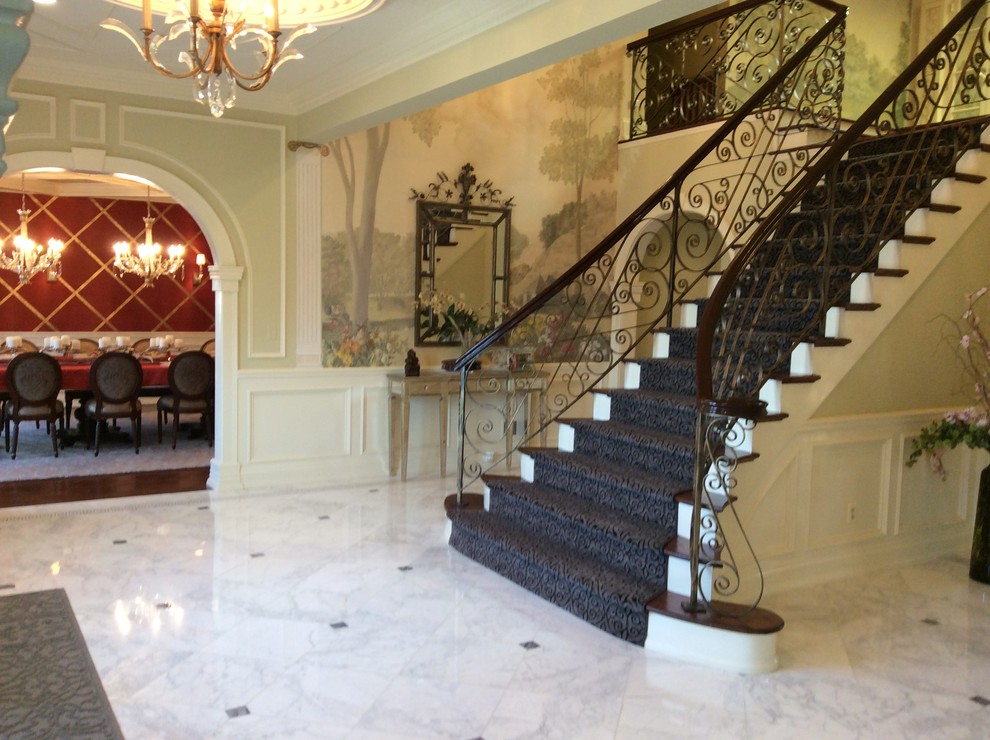 Example of a large transitional marble floor entryway design in New York with green walls and a dark wood front door