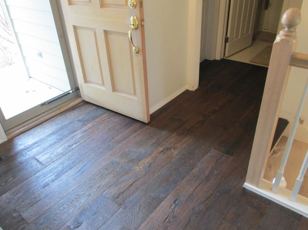 Mid-sized elegant dark wood floor and brown floor entryway photo in Detroit with white walls and a light wood front door