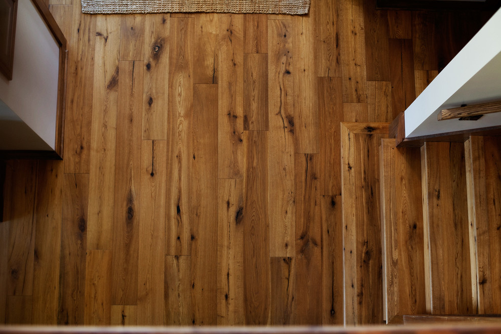 Large rustic foyer in Miami with medium hardwood flooring, white walls and brown floors.