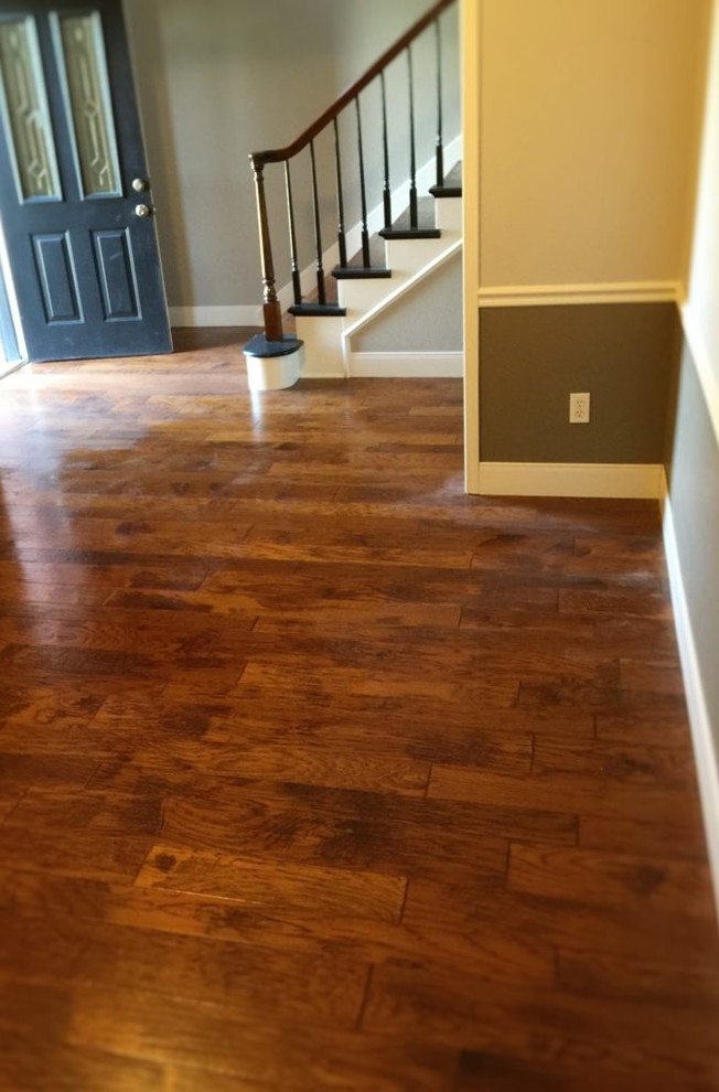 Example of a small classic medium tone wood floor and brown floor entryway design in Houston with gray walls and a blue front door