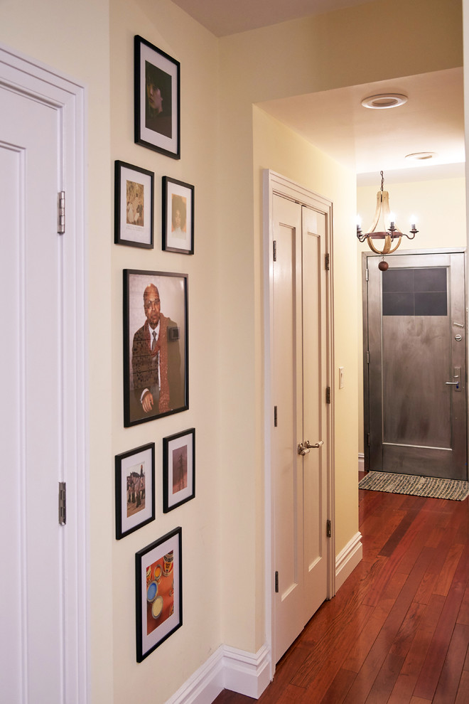 Design ideas for a medium sized eclectic hallway in New York with beige walls, medium hardwood flooring, a single front door and a metal front door.