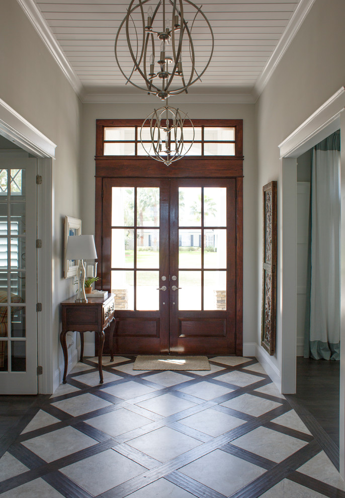 Inspiration for a mid-sized coastal dark wood floor and brown floor entryway remodel in Jacksonville with beige walls and a brown front door