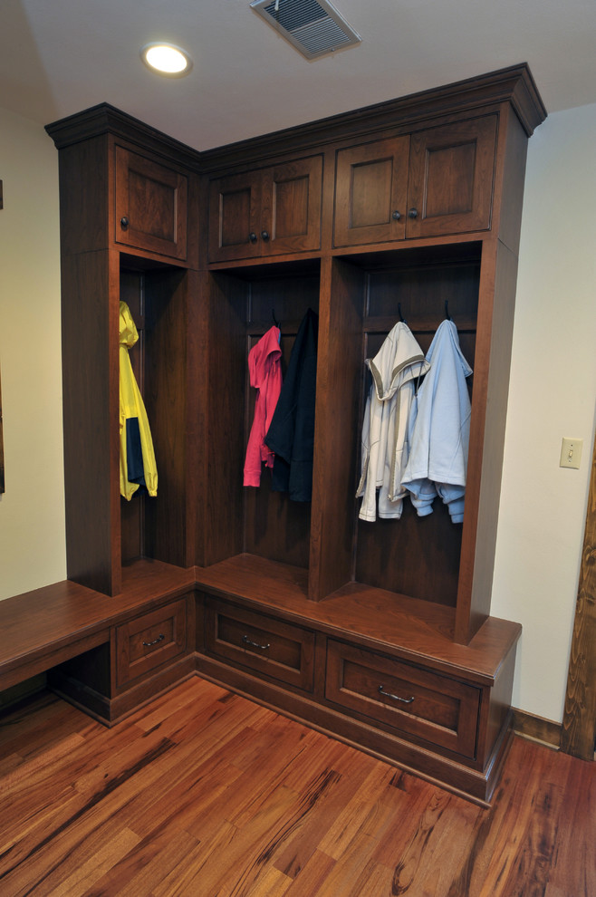 Inspiration for a mid-sized timeless medium tone wood floor mudroom remodel in Milwaukee with beige walls