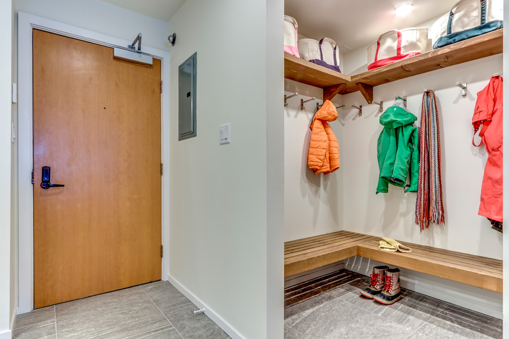 Example of a mid-sized trendy porcelain tile entryway design in Vancouver with white walls and a light wood front door