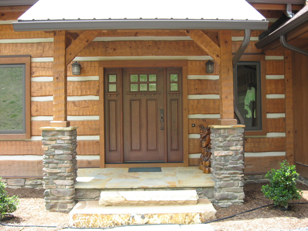 This is an example of a large rustic front door in Charlotte with slate flooring, a single front door and a medium wood front door.