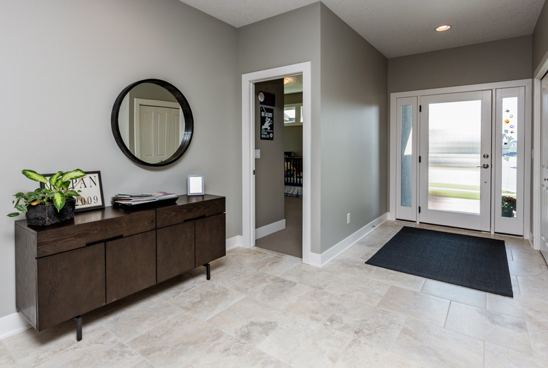 Transitional porcelain tile entryway photo in Other with gray walls and a white front door
