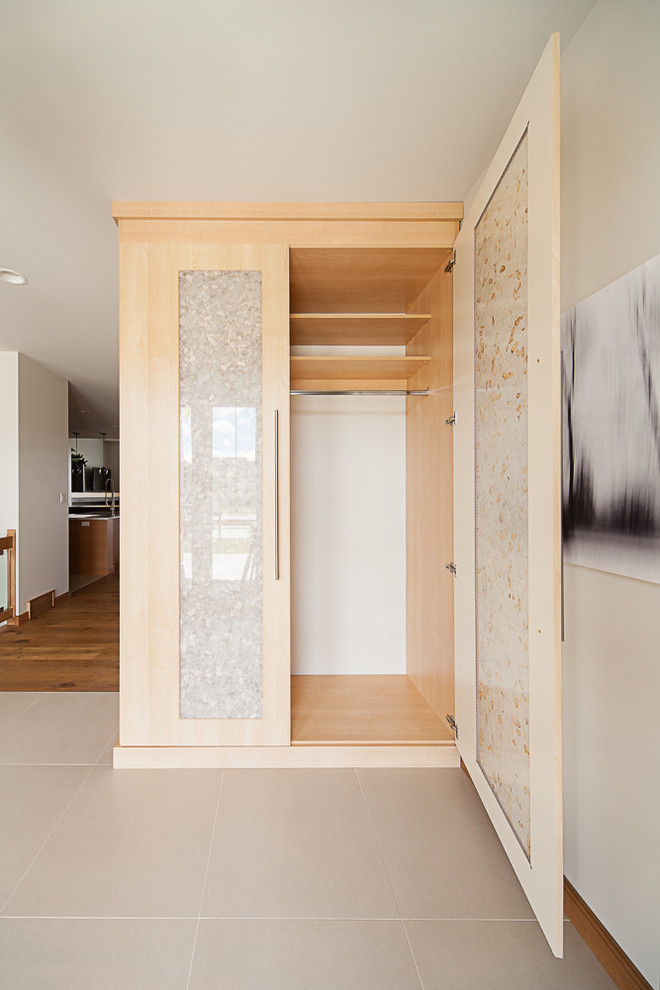Example of a large trendy porcelain tile entryway design in Other with beige walls and a glass front door