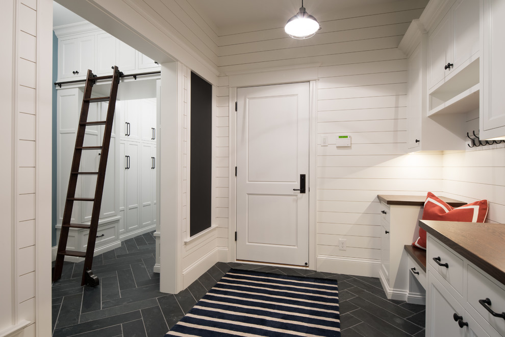 This is an example of a medium sized classic boot room in Minneapolis with white walls, slate flooring, a single front door, a white front door and grey floors.