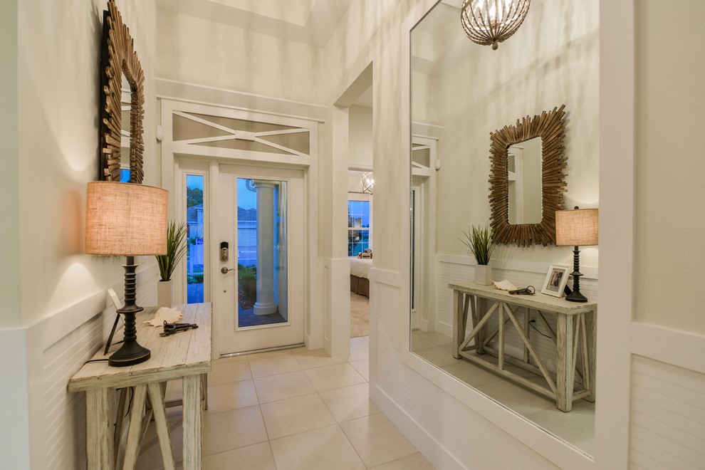 Example of a small transitional entryway design in Tampa with a white front door