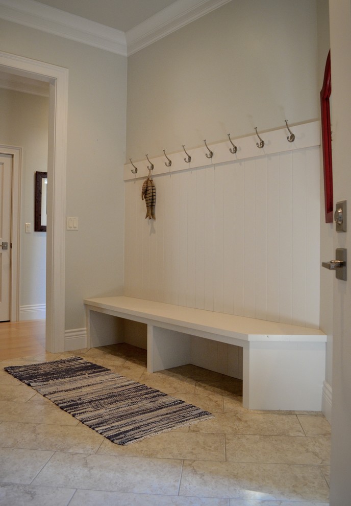 Example of a beach style entryway design in Other with gray walls