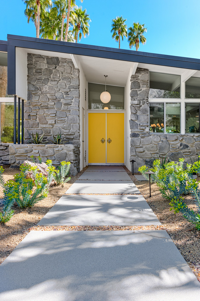 На фото: входная дверь среднего размера в стиле ретро с белыми стенами, двустворчатой входной дверью и желтой входной дверью