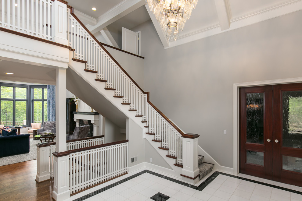 Photo of a large classic foyer in Kansas City with grey walls, marble flooring and white floors.