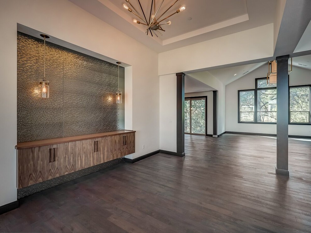 Photo of a large modern foyer in Portland with white walls, dark hardwood flooring, a single front door, a dark wood front door and brown floors.