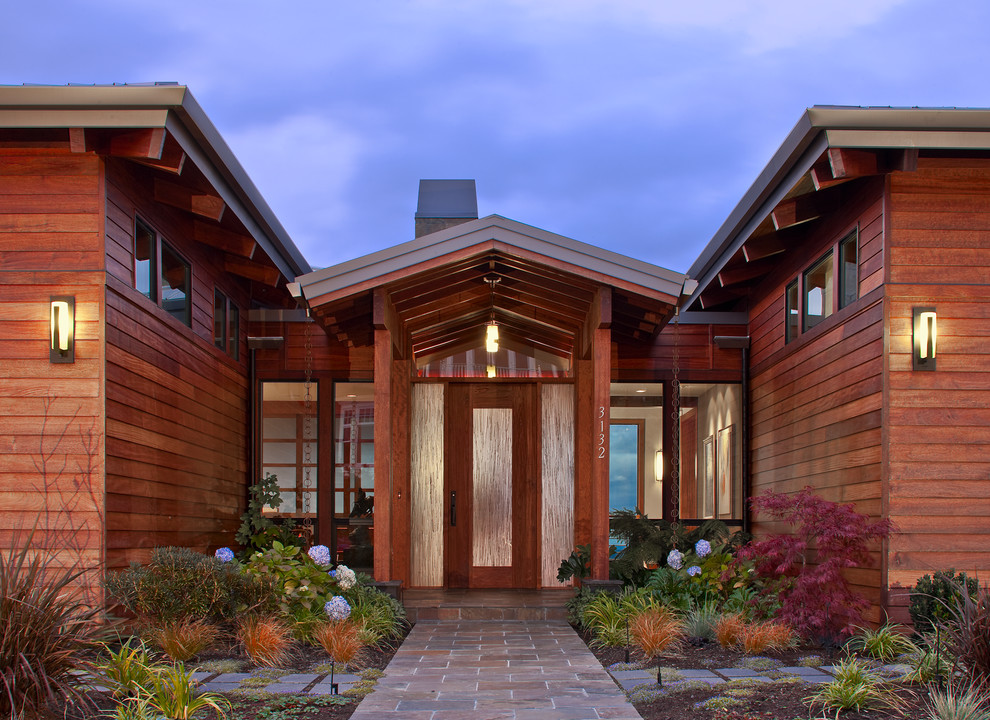 This is an example of a contemporary front door in Seattle with a single front door and a glass front door.