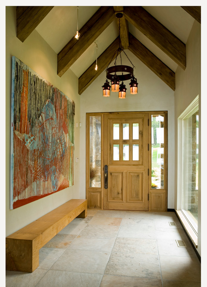 На фото: узкая прихожая среднего размера в современном стиле с бежевыми стенами, полом из керамической плитки, одностворчатой входной дверью и входной дверью из дерева среднего тона
