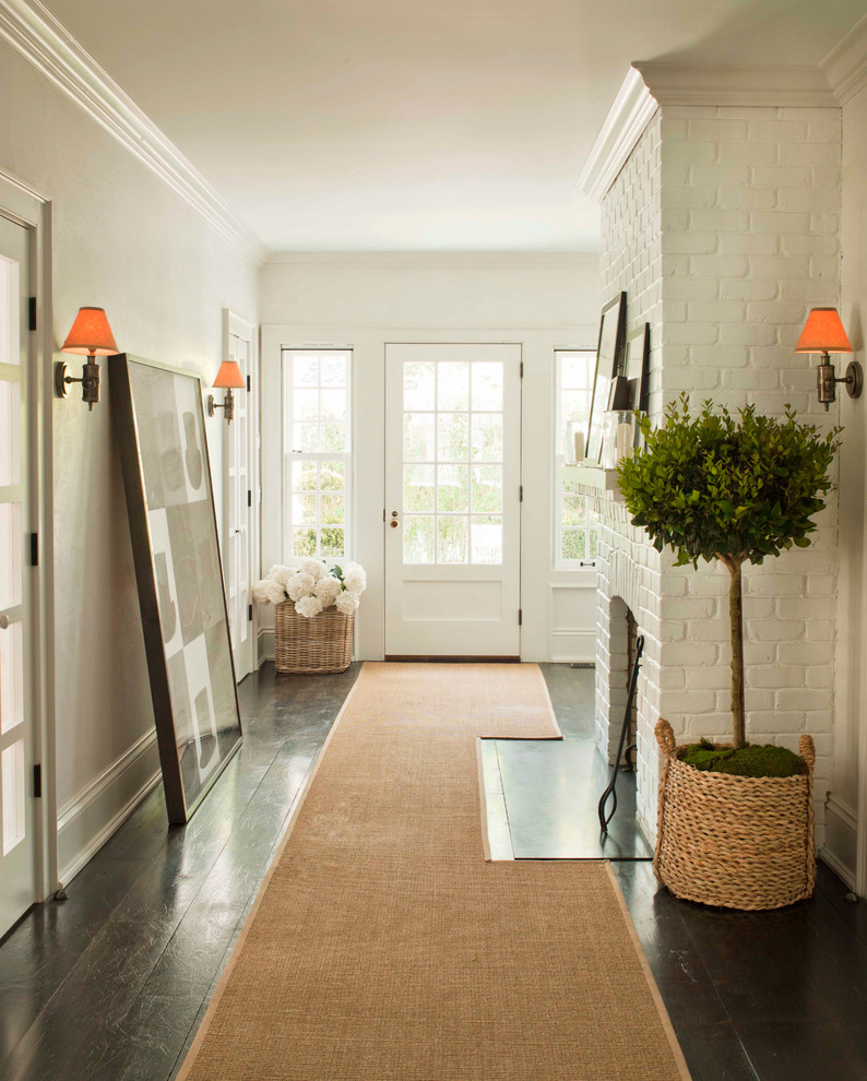 Inspiration for a mid-sized coastal dark wood floor entryway remodel in New York with white walls and a white front door