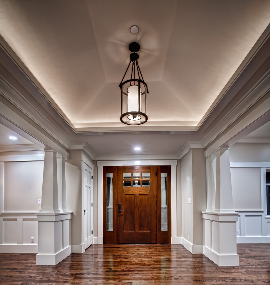 Example of a large arts and crafts dark wood floor entryway design in San Francisco with gray walls and a dark wood front door