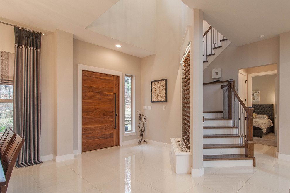 This is an example of a contemporary foyer in Dallas with grey walls, porcelain flooring, a pivot front door, a medium wood front door and white floors.