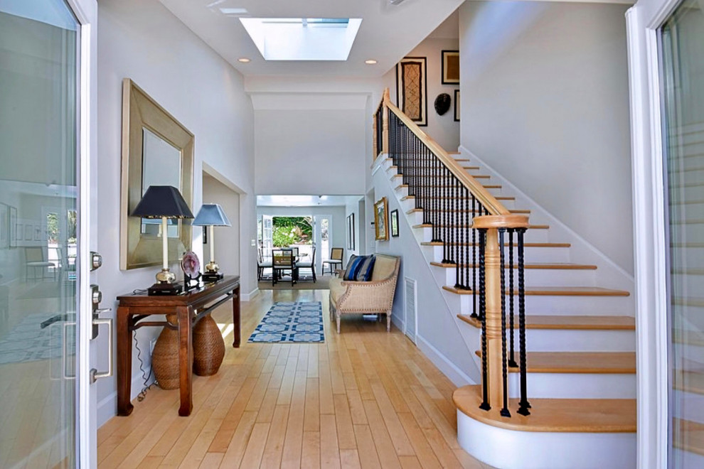 Entryway - large transitional light wood floor, beige floor and vaulted ceiling entryway idea in Los Angeles with gray walls and a white front door
