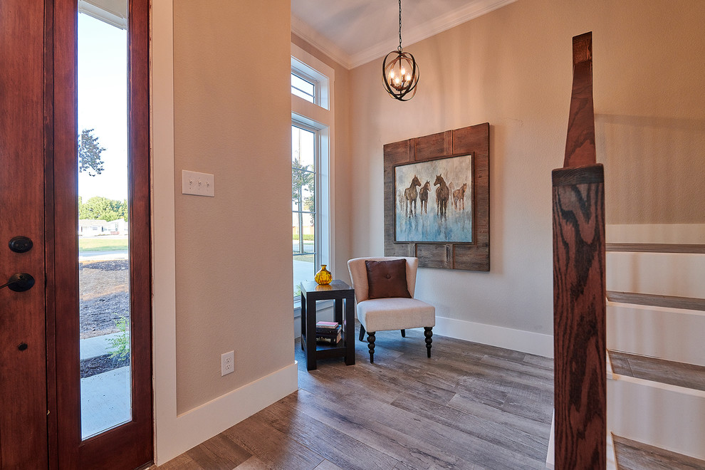 This is an example of a large country foyer in Dallas with grey walls, porcelain flooring, a single front door, a medium wood front door and grey floors.