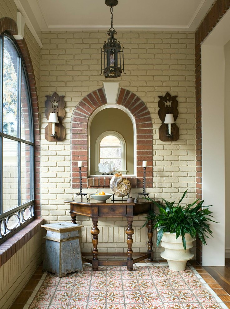 Example of an eclectic entryway design in Denver with beige walls