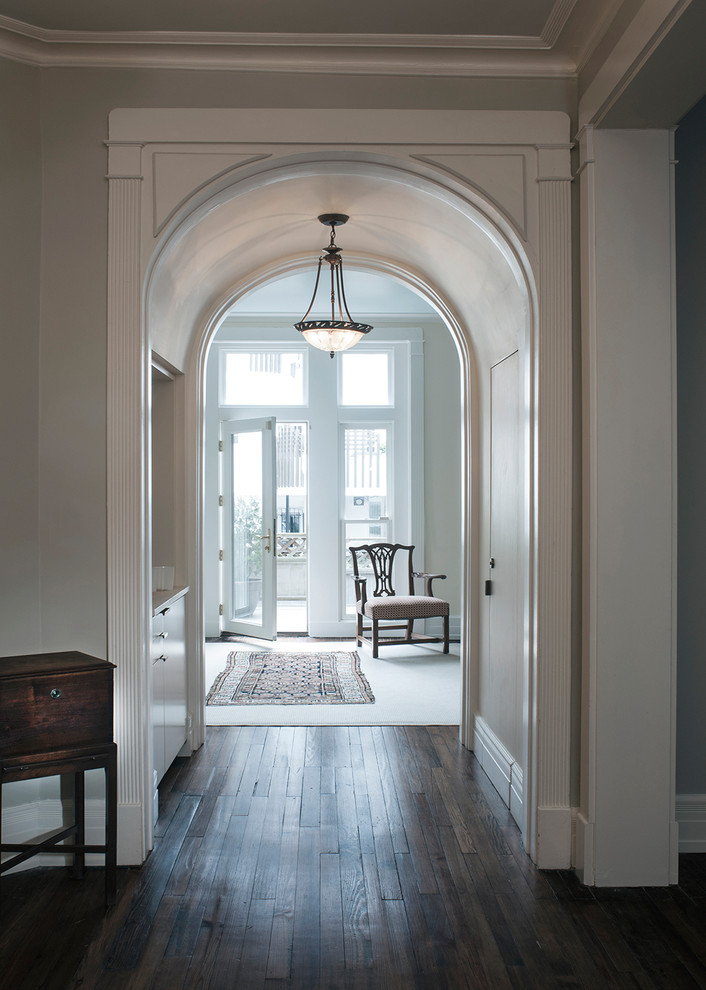 Inspiration for a classic foyer in DC Metro with grey walls, dark hardwood flooring, a single front door, a glass front door and brown floors.