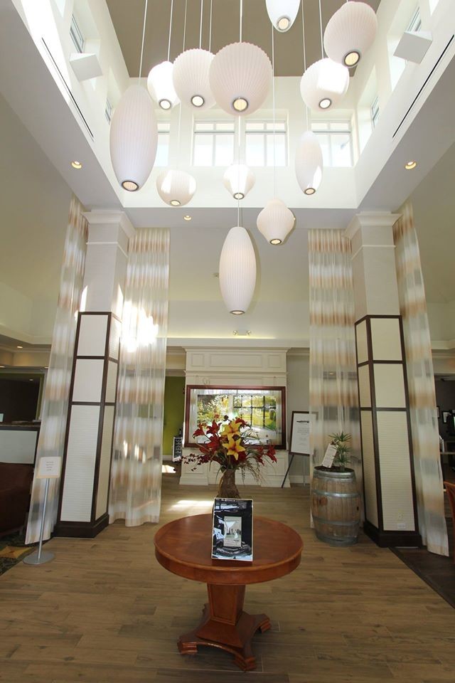 Photo of a large contemporary vestibule in New York with green walls and medium hardwood flooring.