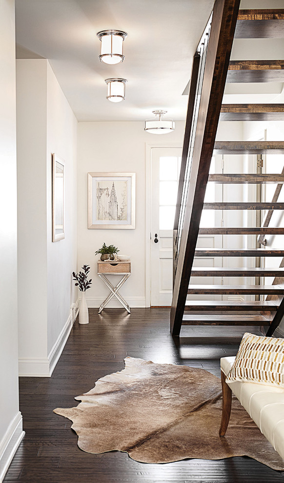 Inspiration for a small farmhouse dark wood floor and brown floor entryway remodel in Seattle with white walls and a white front door