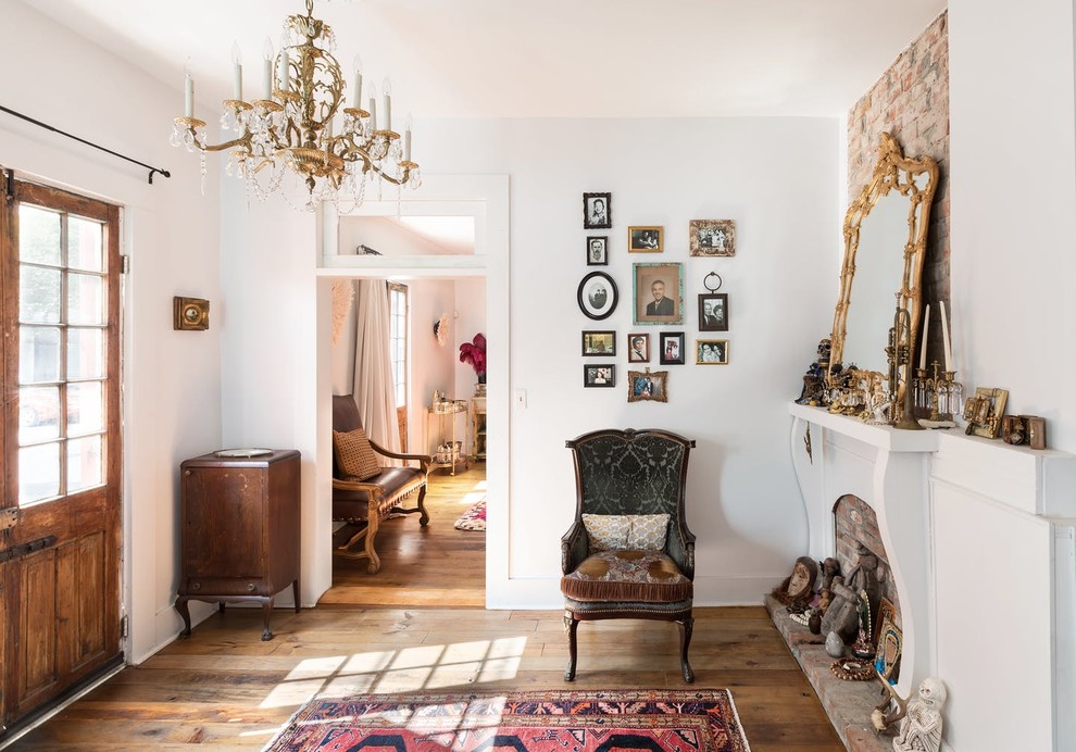 Inspiration for an eclectic medium tone wood floor and brown floor entryway remodel in New Orleans with white walls and a glass front door