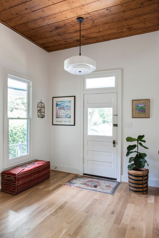 This is an example of a traditional entrance in Houston with light hardwood flooring.