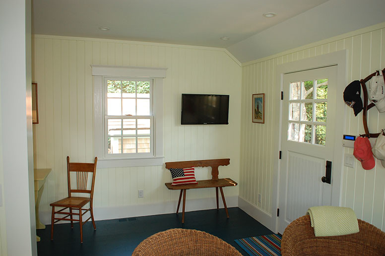 Small beach style dark wood floor pivot front door photo in Boston with yellow walls and a white front door