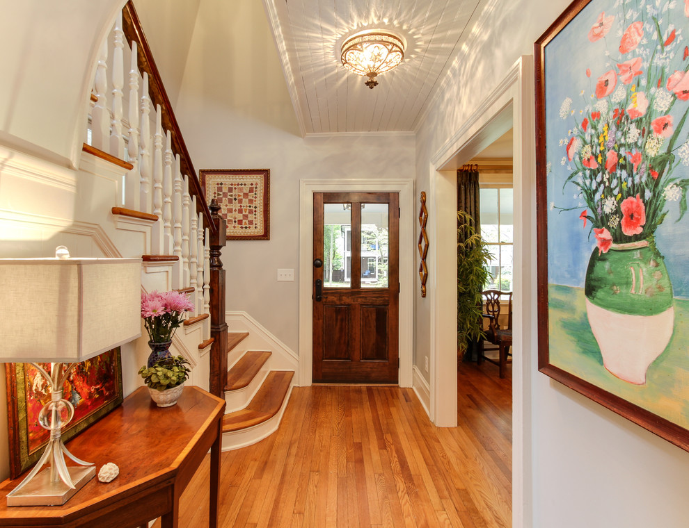 Mid-sized elegant medium tone wood floor entryway photo in Raleigh with gray walls and a dark wood front door
