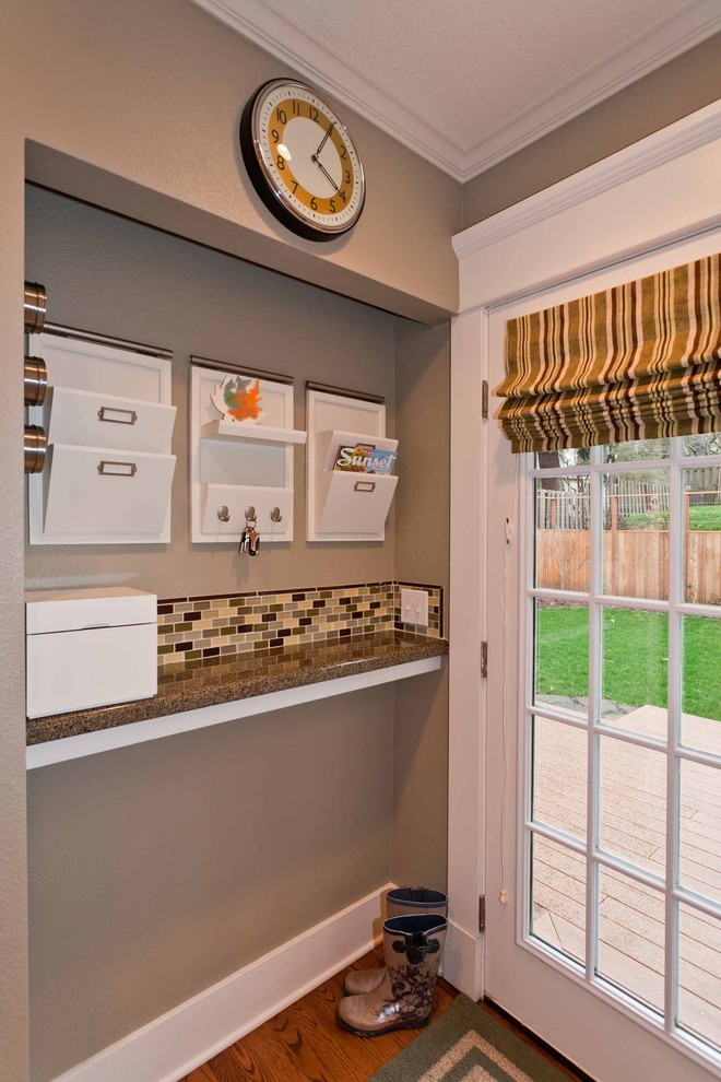 Mid-sized elegant medium tone wood floor entryway photo in Portland with multicolored walls and a glass front door