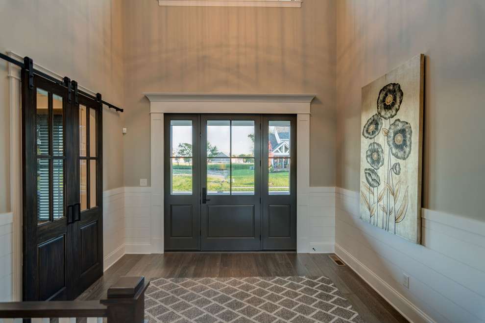Idee per una porta d'ingresso minimalista con pareti beige, pavimento in legno massello medio, una porta a due ante e una porta in legno scuro