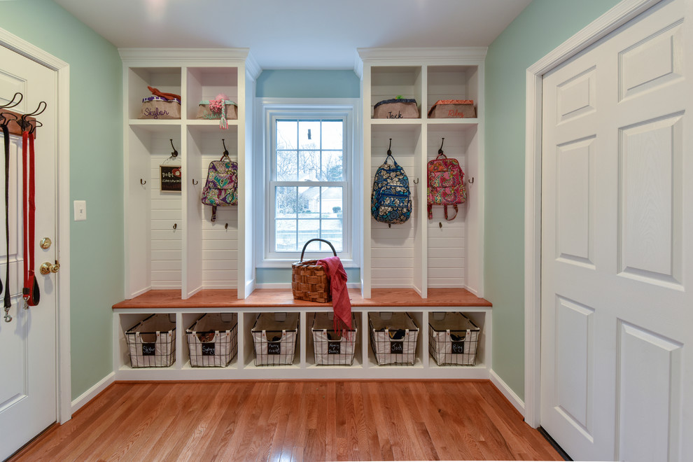 Inspiration for a medium sized contemporary boot room in DC Metro with blue walls, medium hardwood flooring, a single front door and a white front door.