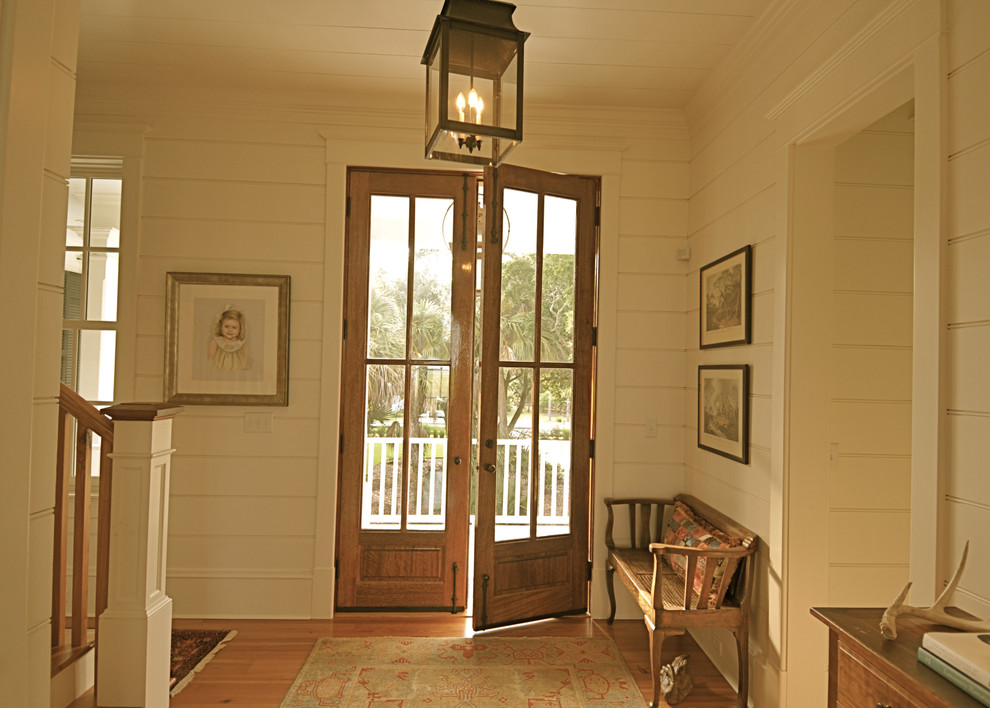 Example of a classic double front door design in Charleston with beige walls