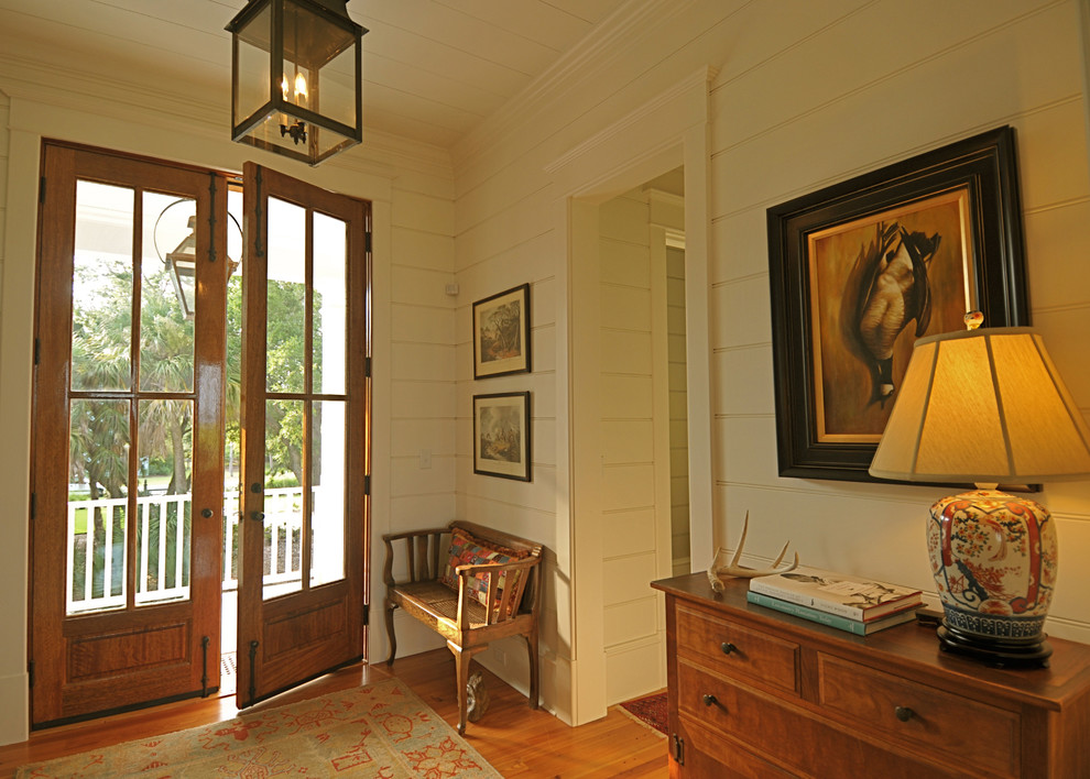 Inspiration for a timeless double front door remodel in Charleston with beige walls and a glass front door
