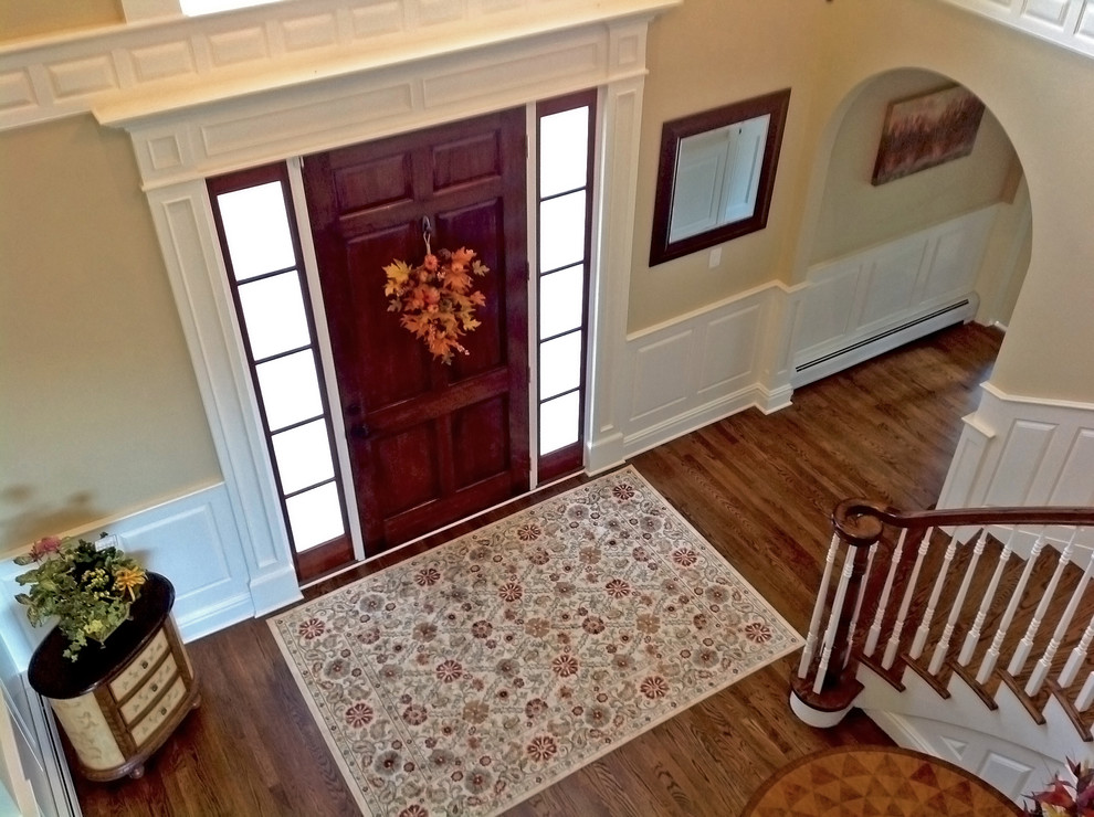 Design ideas for a large traditional front door in New York with beige walls, medium hardwood flooring, a single front door and a dark wood front door.