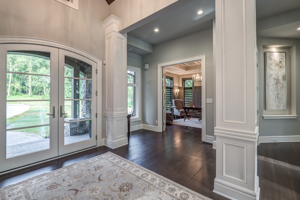 Inspiration for a large transitional dark wood floor and brown floor entryway remodel in Cincinnati with gray walls and a glass front door
