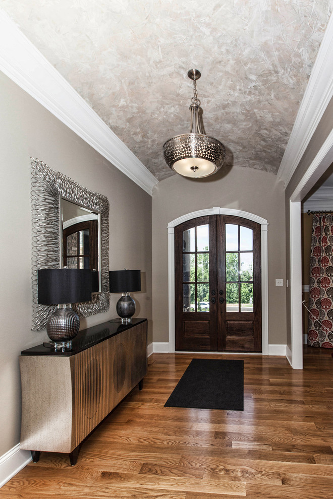Inspiration for a mid-sized transitional light wood floor entryway remodel in Louisville with a brown front door