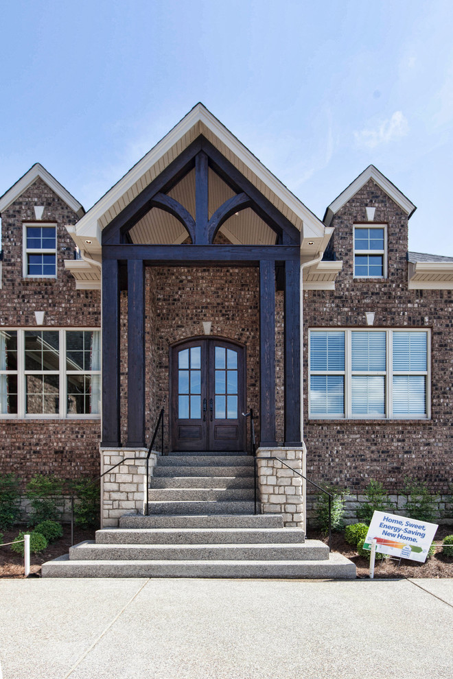 На фото: входная дверь среднего размера в стиле кантри с бетонным полом, двустворчатой входной дверью и коричневой входной дверью