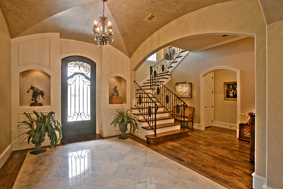 Inspiration for a mid-sized timeless medium tone wood floor entryway remodel in Dallas with beige walls and a metal front door