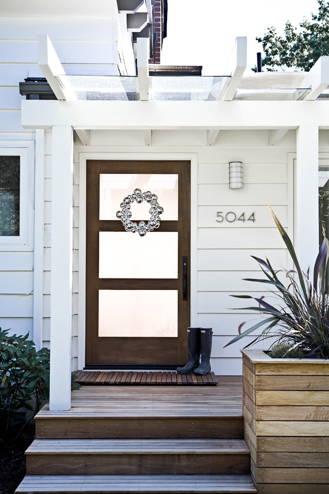 Inspiration for a timeless entryway remodel in Portland with a glass front door