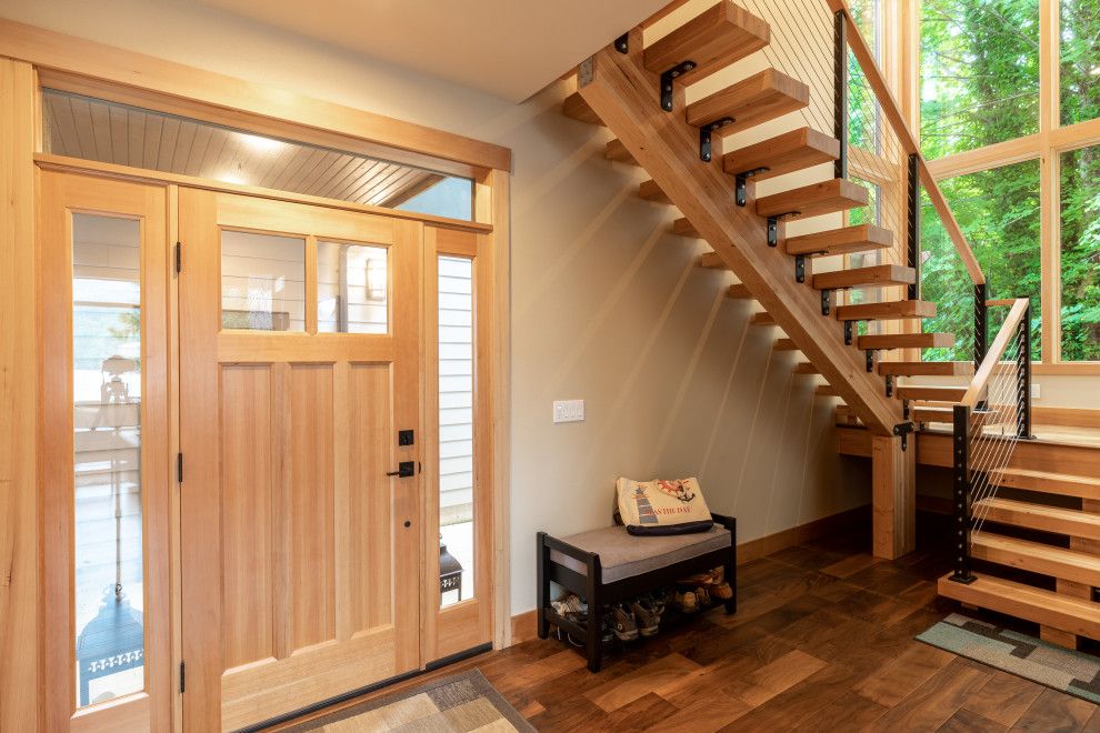 Entryway - contemporary entryway idea in Seattle with a light wood front door