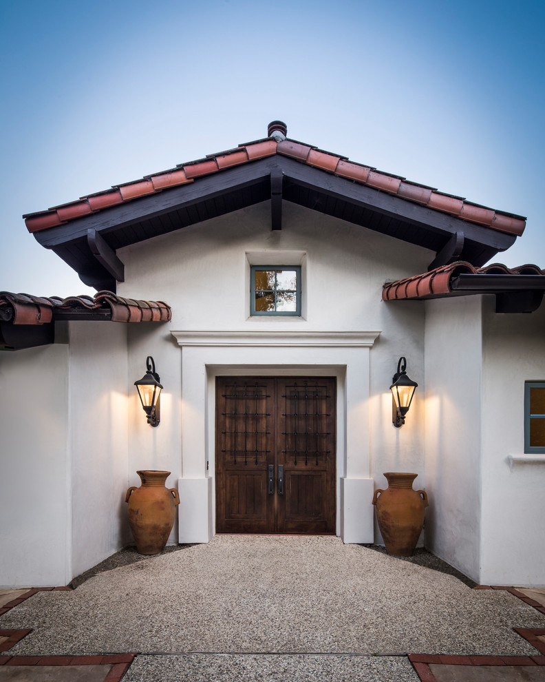 Design ideas for a large mediterranean front door in Santa Barbara with white walls, a double front door and a dark wood front door.